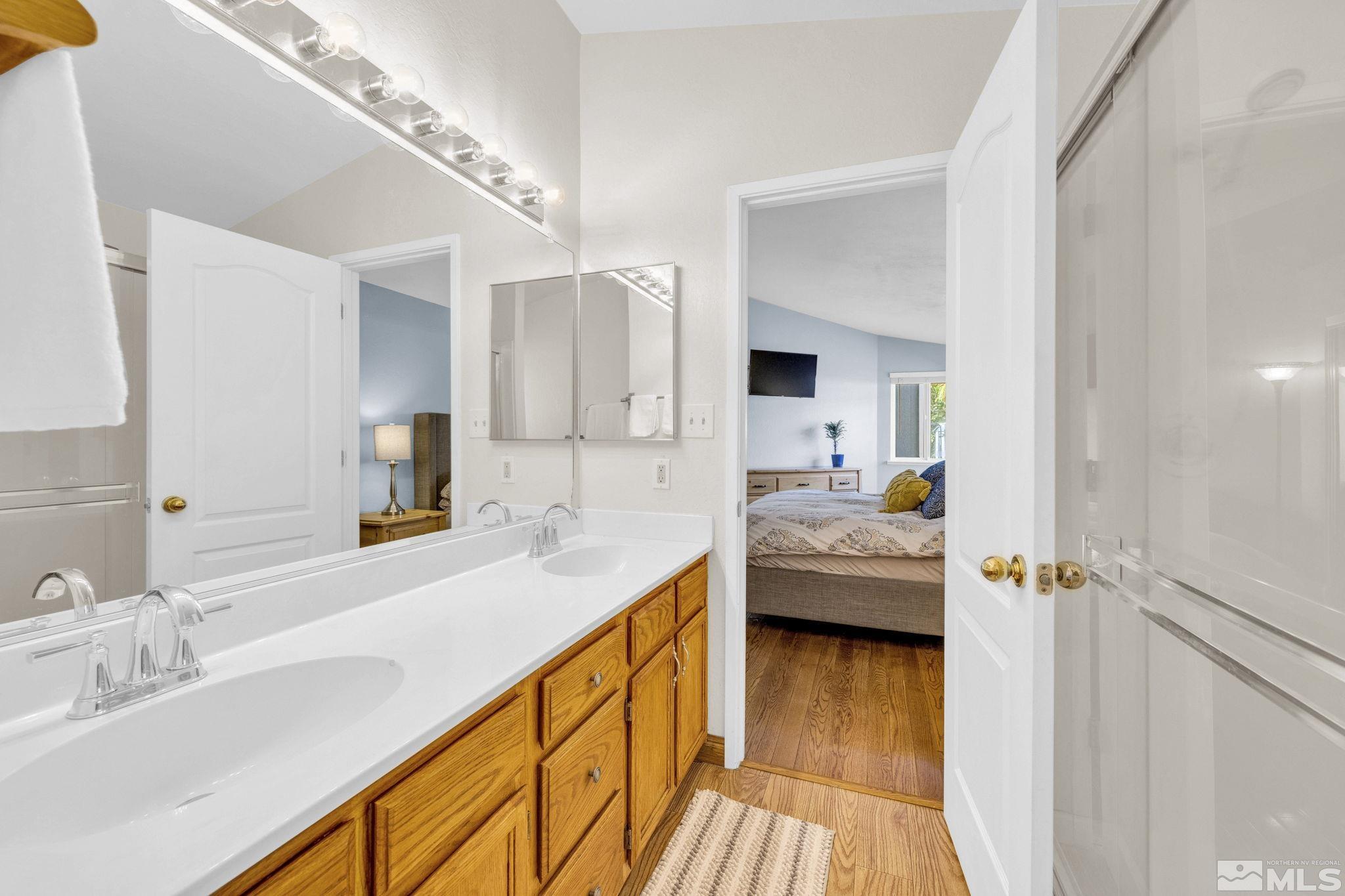 6314 Chesterfield Lane Reno, NV 89523 - Photo 20 of 35 a en suite bathroom with a granite countertop sink and a mirror