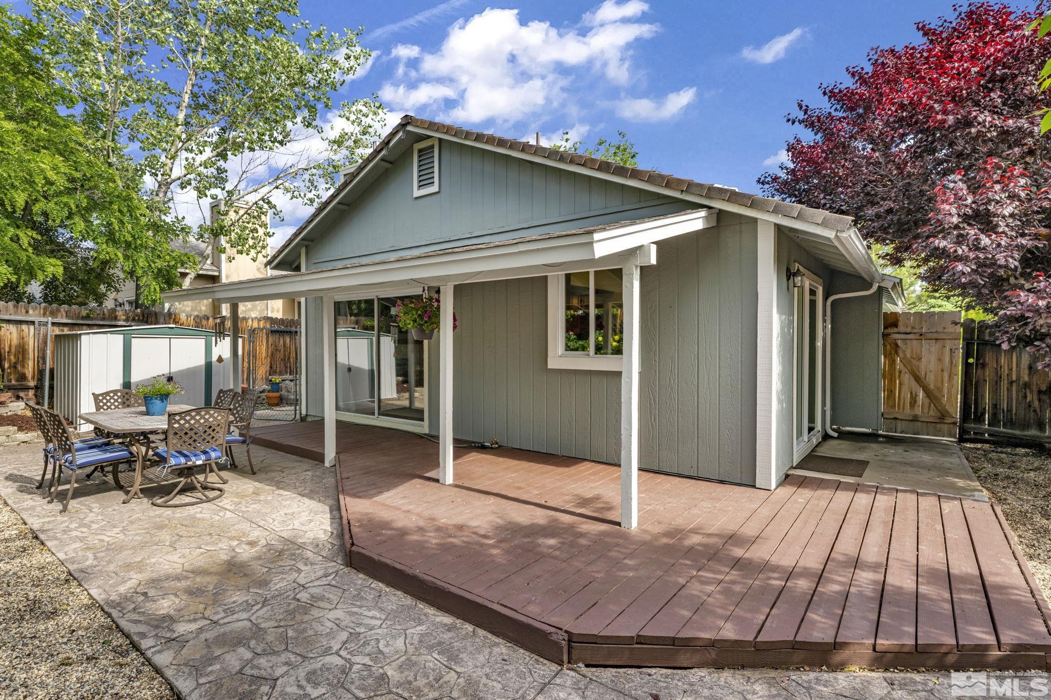 6314 Chesterfield Lane Reno, NV 89523 - Photo 29 of 35 a view of backyard with large trees and a wooden fence