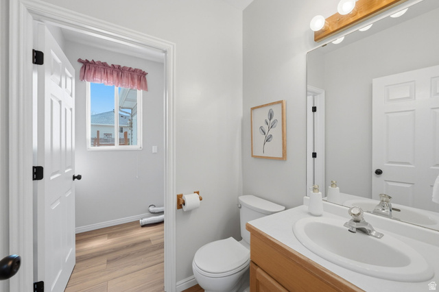 3732 Campbell Road Tooele, UT 84074 - Photo 21 of 69 Bathroom featuring a single vanity with an integrated sink, wood-finish cabinetry, and a framed mirror