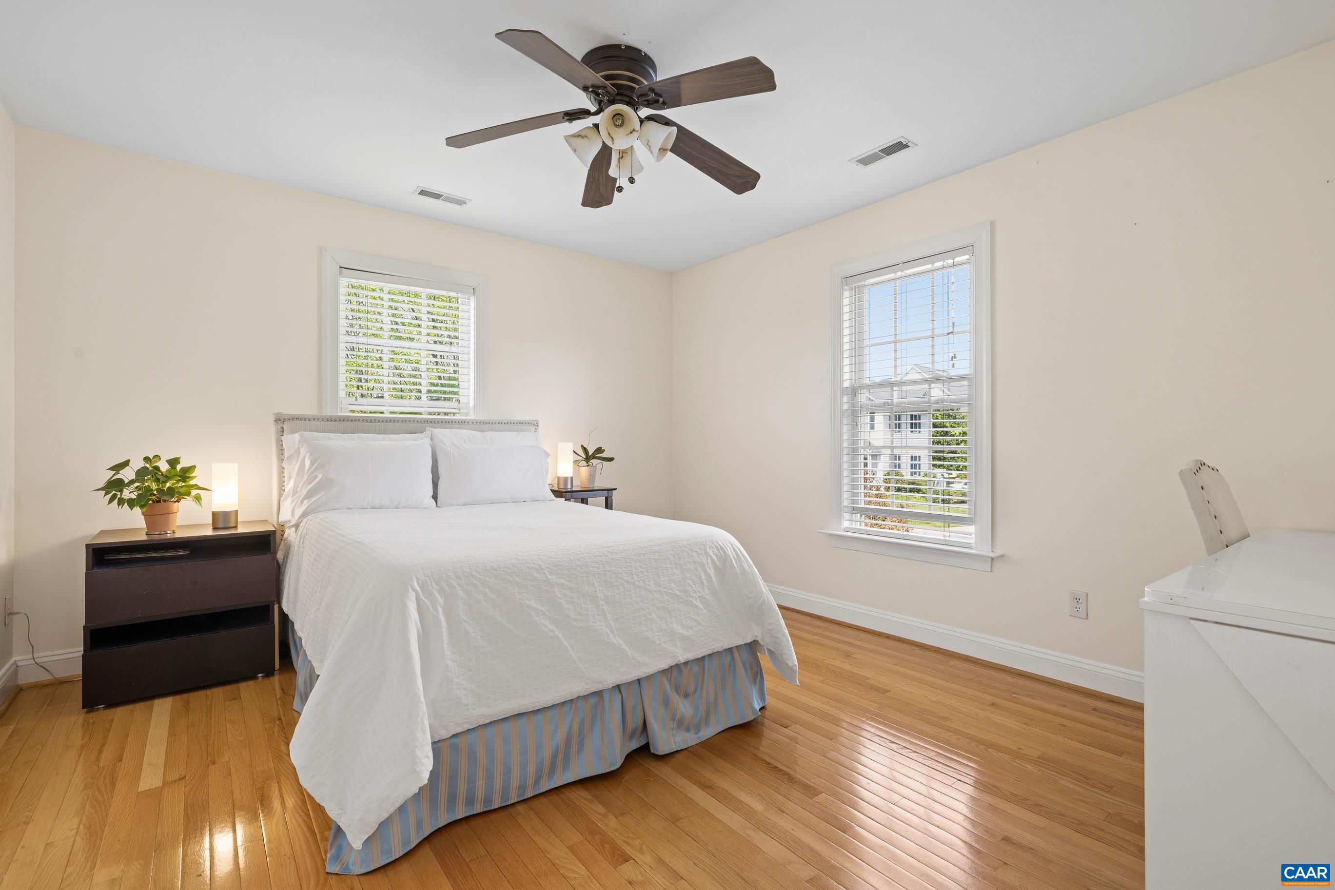 1236 Amber Ridge Road Charlottesville, VA 22901 - Photo 24 of 56 a bedroom with a bed lamps and a chandelier