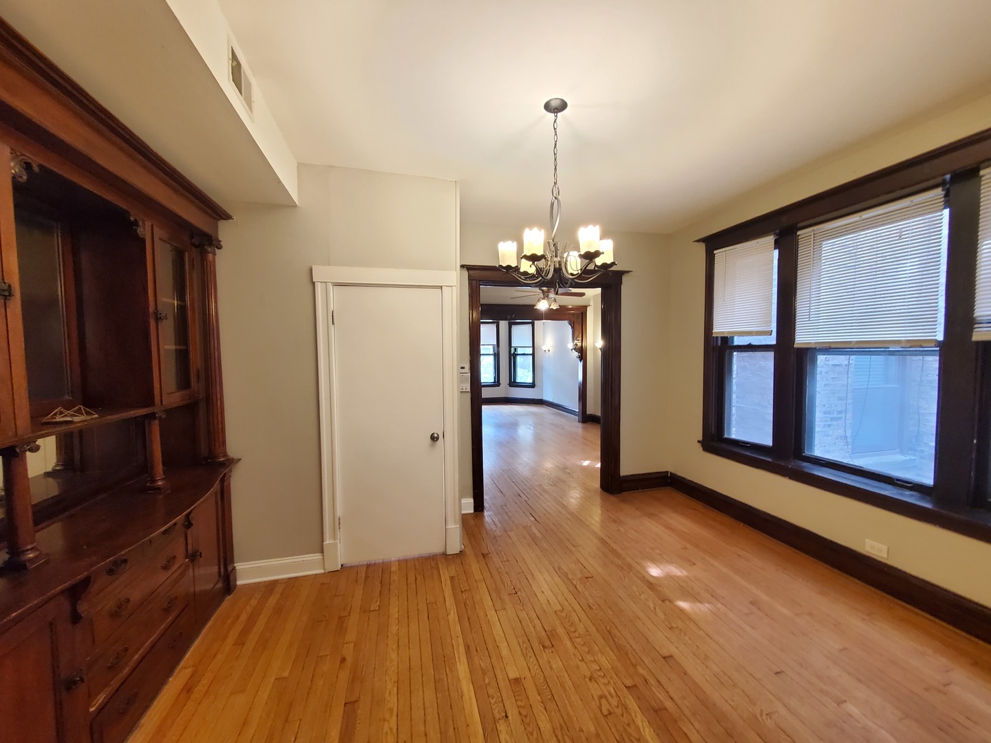 665 West Roscoe Street, Unit 1 Chicago, IL 60657 - Photo 4 of 10 wooden floor in an empty room with a window