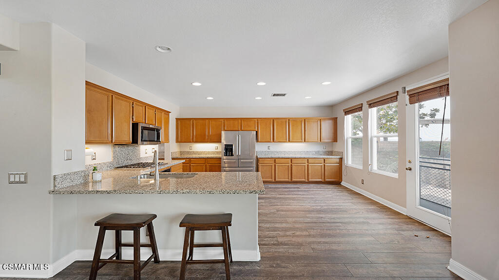 3443 Pine View Drive Simi Valley, CA 93065 - Photo 11 of 32 a kitchen with granite countertop a stove a sink a dining table and chairs