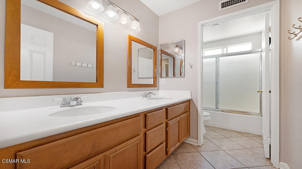 3443 Pine View Drive Simi Valley, CA 93065 - Photo 19 of 32 a bathroom with a double vanity sink and mirror