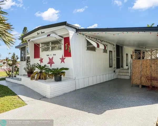 a front view of a building with potted plants