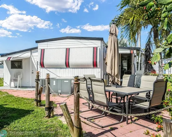 a view of a backyard with a patio and outdoor seating