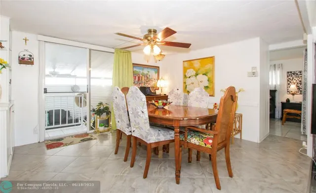 a view of a dining room with furniture and a chandelier