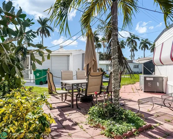 a view of outdoor sitting area with chairs and a table