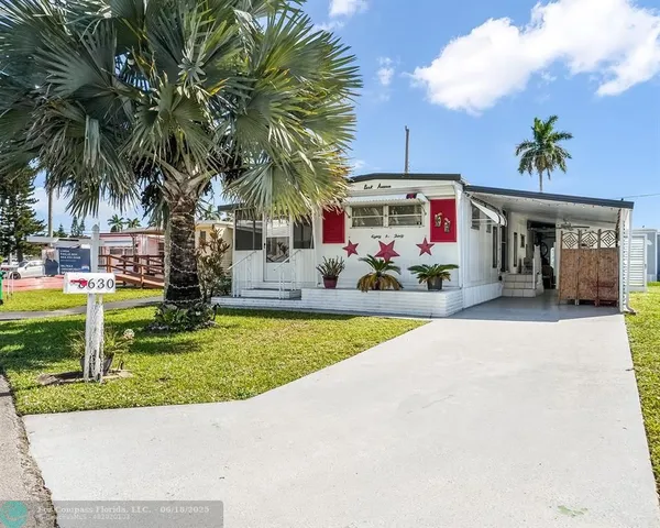 a front view of house with yard and outdoor seating