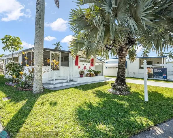 a view of a house with swimming pool and sitting area