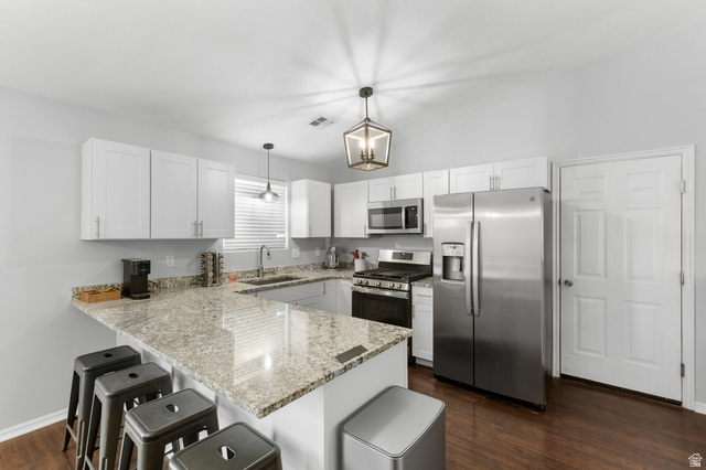 664 East Springhill Drive Washington, UT 84780 - Photo 4 of 21 Kitchen featuring white shaker-style cabinetry, light-toned granite countertops, stainless steel appliances, and wood-finish flooring