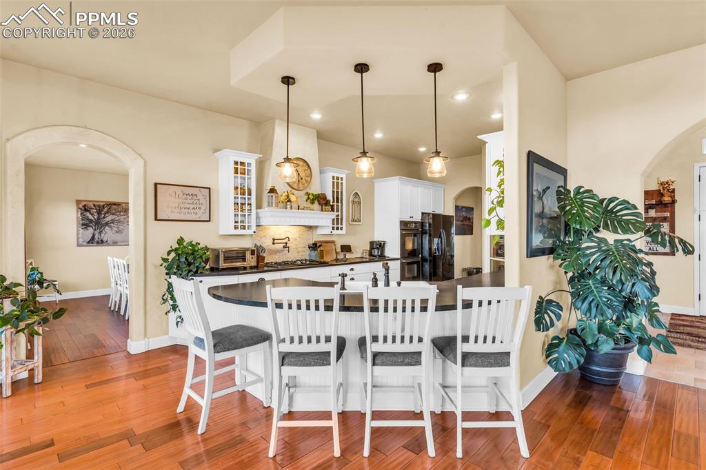 204 Storm Ridge Drive Canon City, CO 81212 - Photo 12 of 50 a view of a dining room with furniture and wooden floor