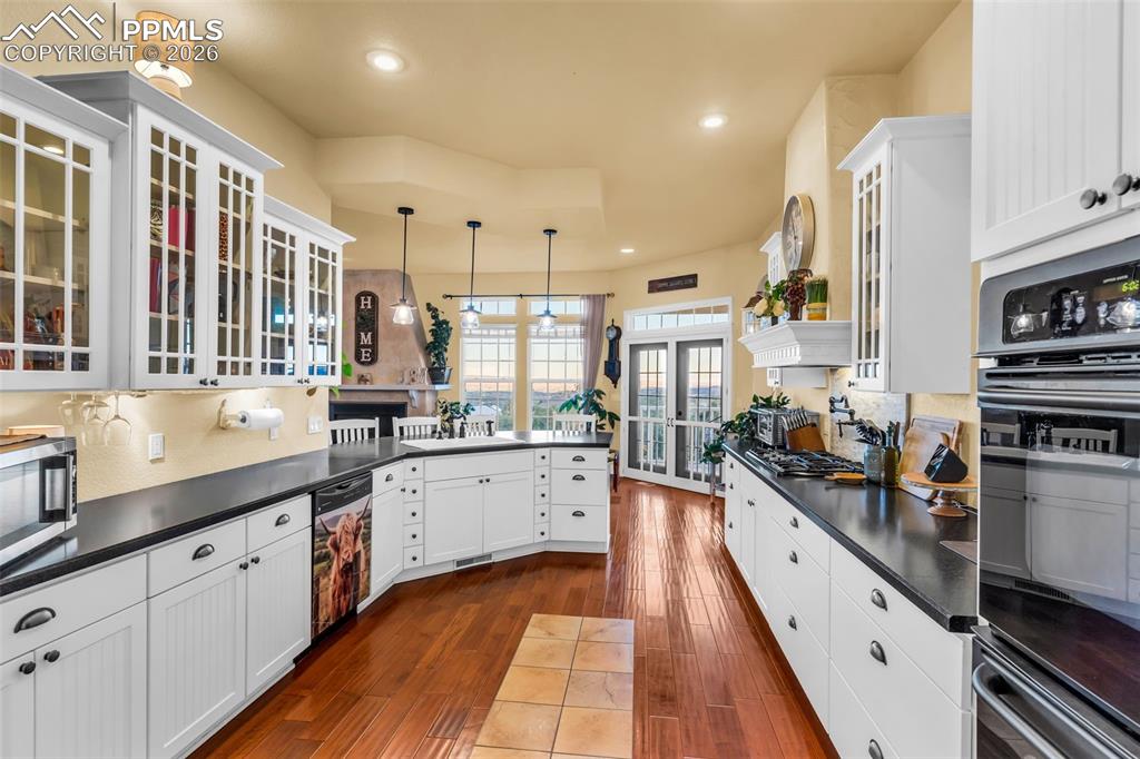 204 Storm Ridge Drive Canon City, CO 81212 - Photo 16 of 50 a large kitchen with stainless steel appliances sink a stove and cabinets