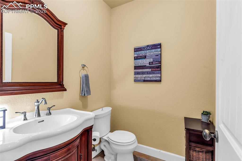 204 Storm Ridge Drive Canon City, CO 81212 - Photo 20 of 50 a bathroom with a sink a toilet and mirror