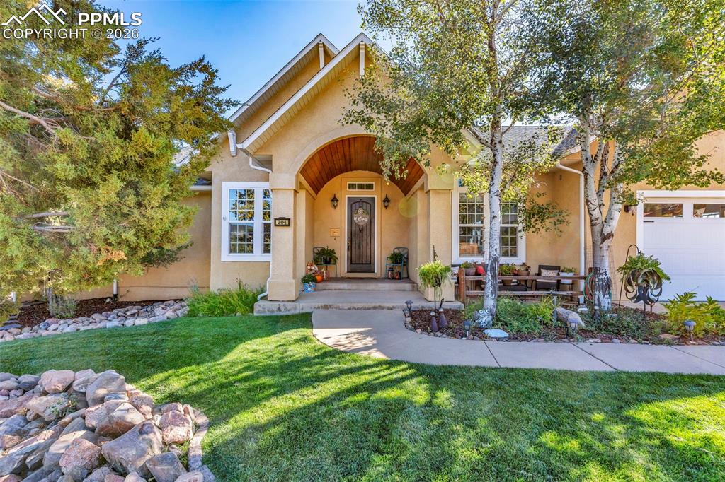 204 Storm Ridge Drive Canon City, CO 81212 - Photo 2 of 50 a front view of house with a garden and patio