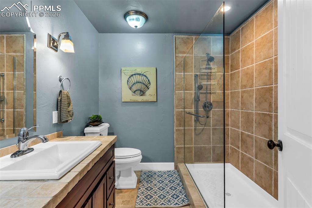 204 Storm Ridge Drive Canon City, CO 81212 - Photo 34 of 50 a bathroom with a sink a toilet and shower