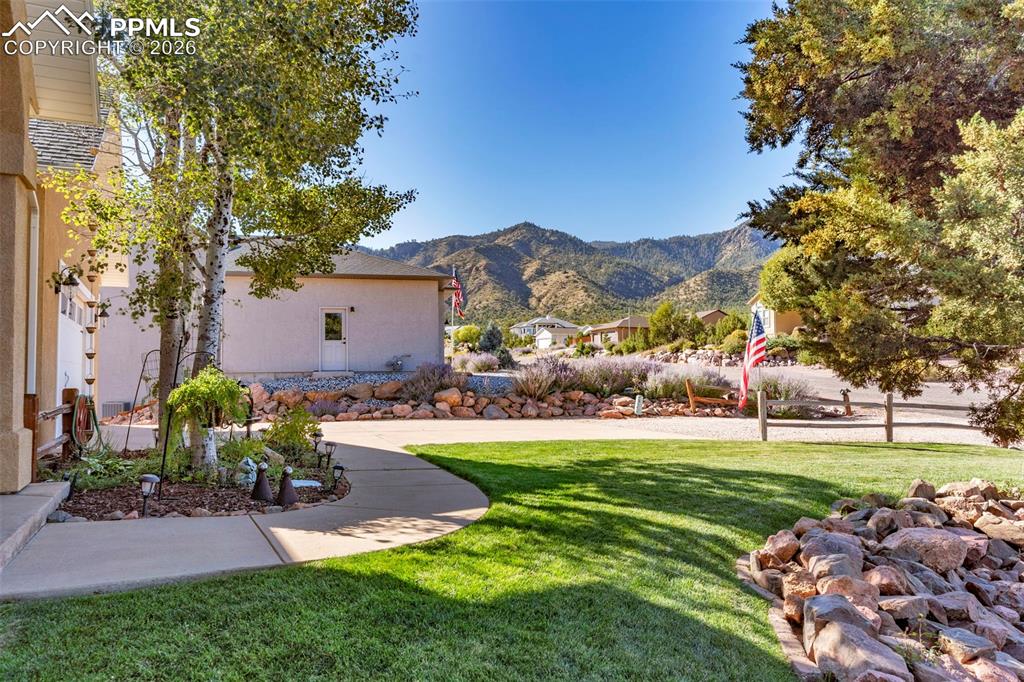 204 Storm Ridge Drive Canon City, CO 81212 - Photo 4 of 50 a front view of a house with a garden and yard