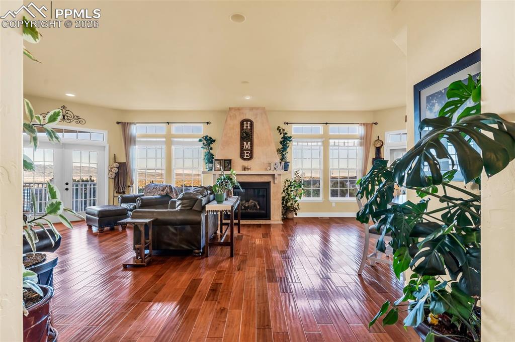 204 Storm Ridge Drive Canon City, CO 81212 - Photo 7 of 50 a living room with furniture floor to ceiling window and wooden floor