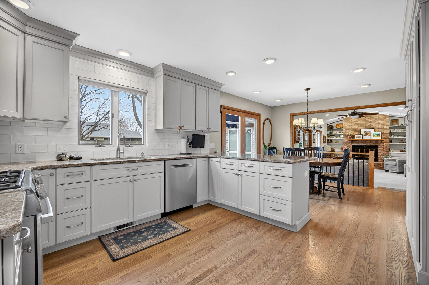 3615 74th Street Moline, IL 61265 - Photo 15 of 44 a kitchen with sink cabinets and wooden floor
