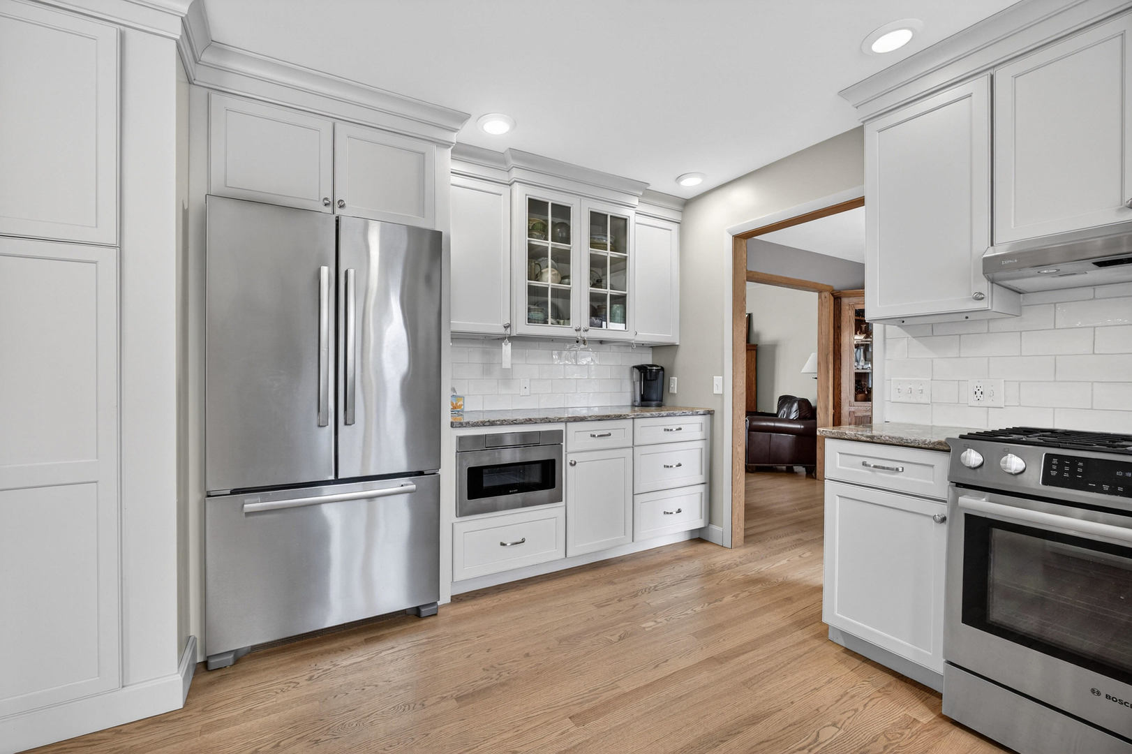 3615 74th Street Moline, IL 61265 - Photo 16 of 44 a kitchen with granite countertop stainless steel appliances a refrigerator cabinets and wooden floor