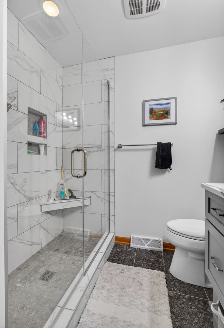 3615 74th Street Moline, IL 61265 - Photo 29 of 44 a bathroom with a toilet a sink and shower