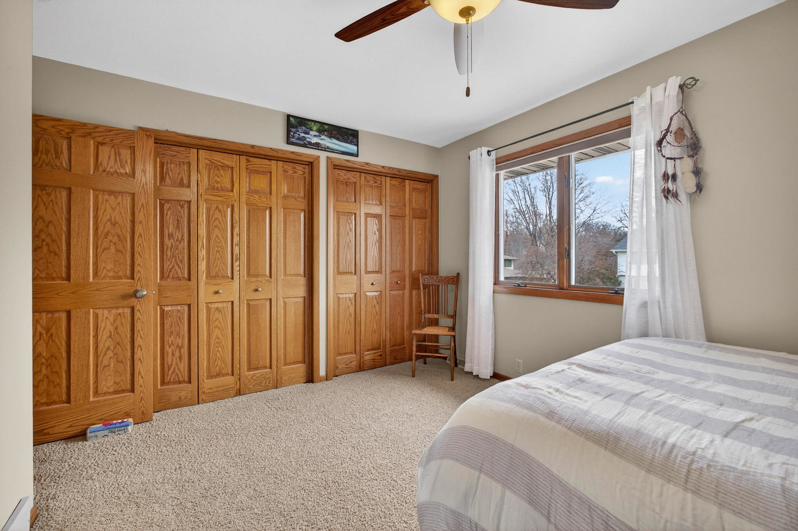 3615 74th Street Moline, IL 61265 - Photo 31 of 44 a bedroom with a large bed and a chandelier