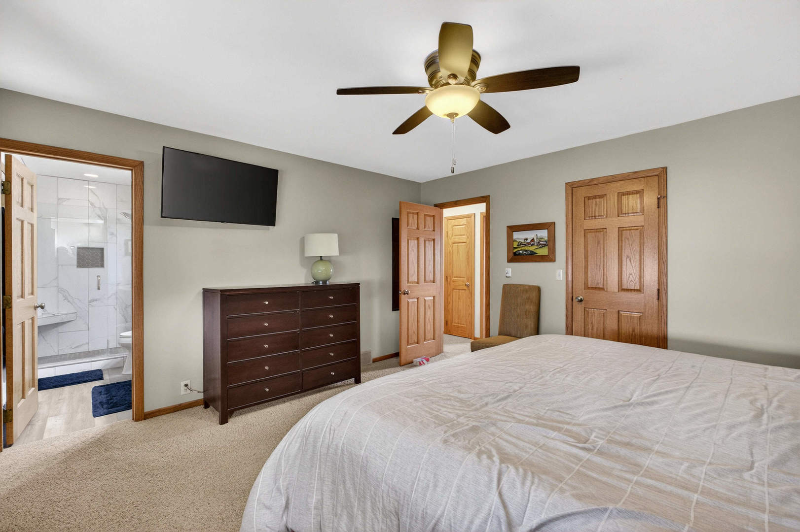 3615 74th Street Moline, IL 61265 - Photo 33 of 44 a bedroom with a bed and a flat tv screen on dresser