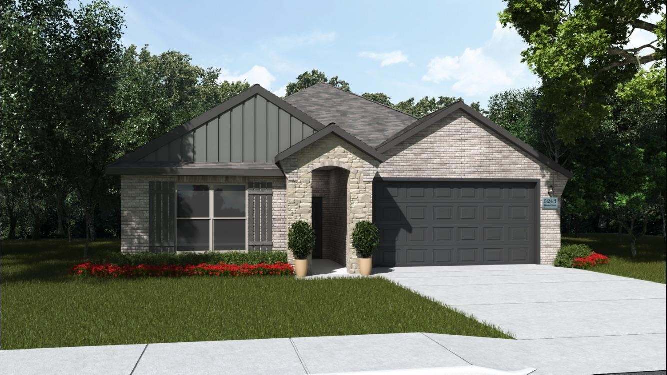 a front view of a house with a garden and yard