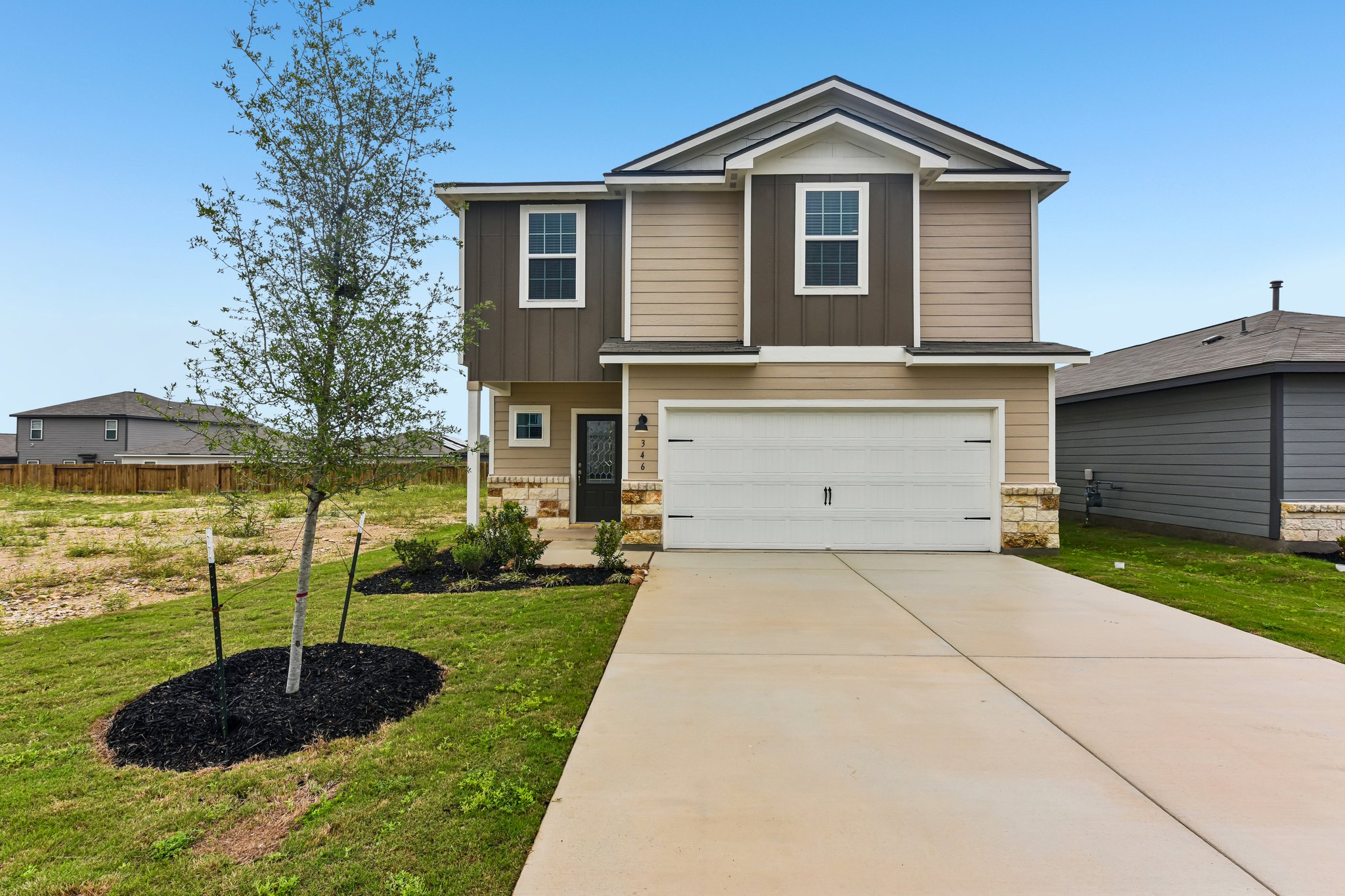 Two-story residence featuring a two-car garage with a concrete driveway