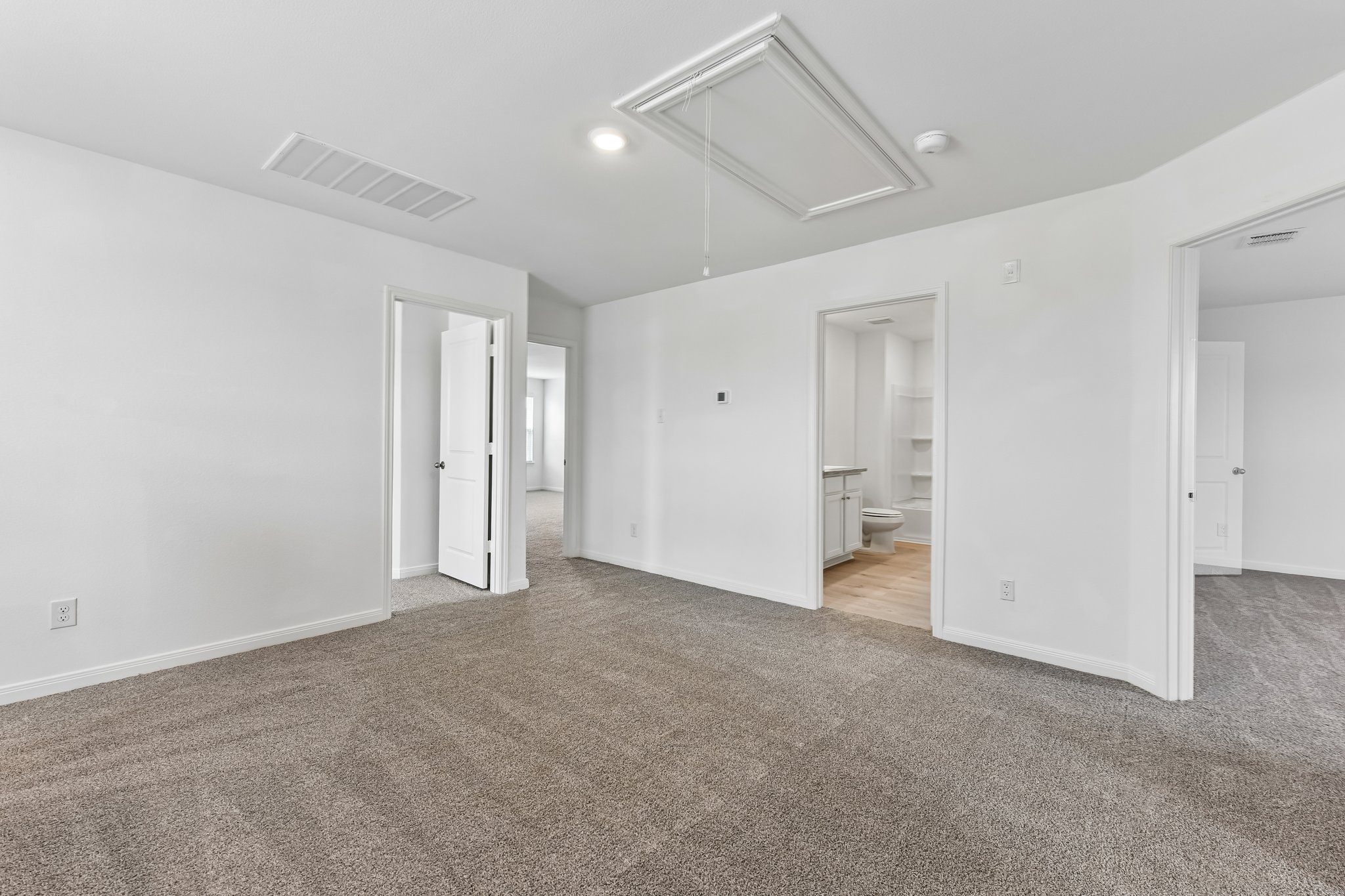346 Low Pasture Trail Maxwell, TX 78656 - Photo 11 of 29 Carpeted room featuring white painted walls and multiple doorways