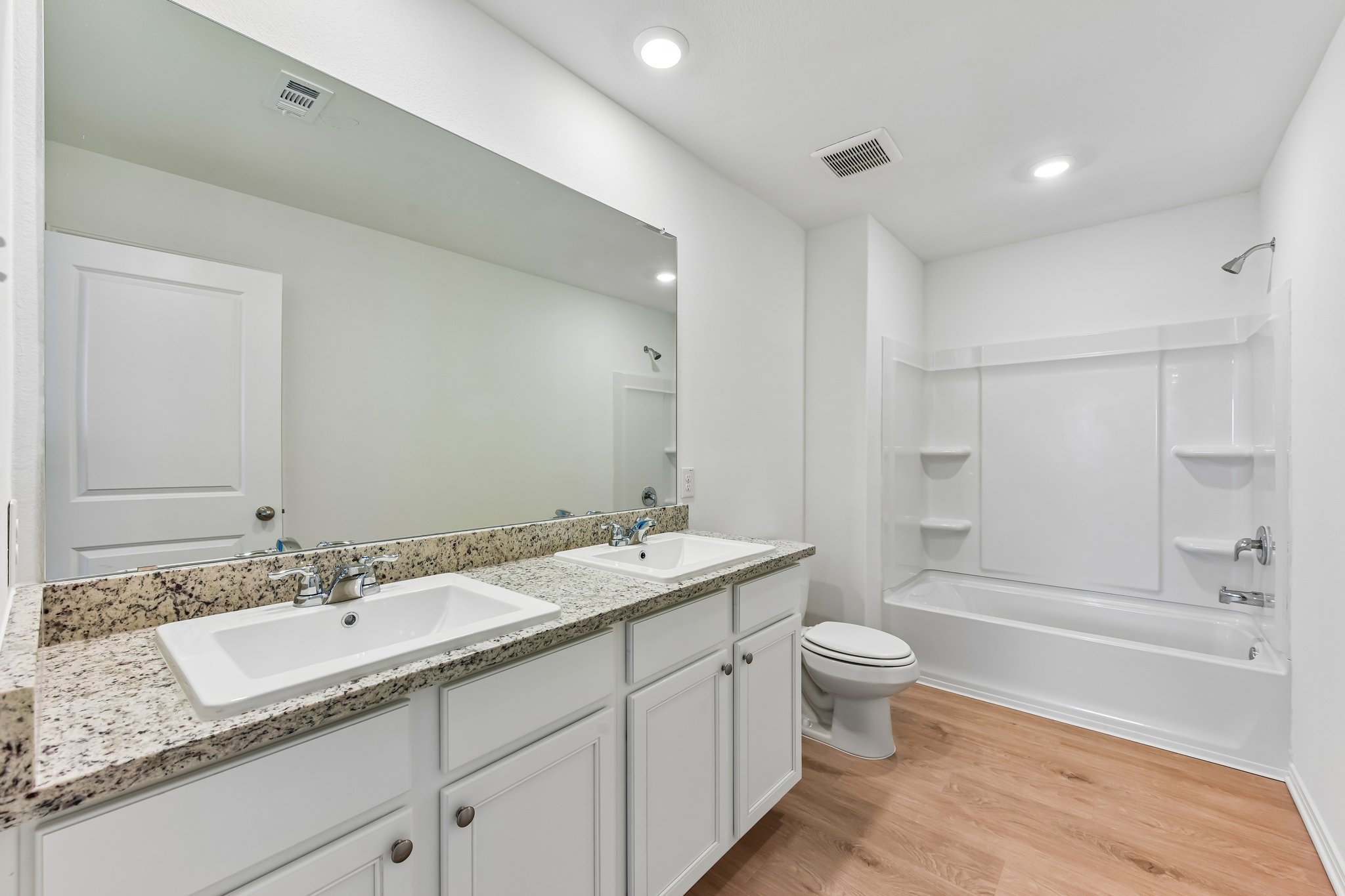 346 Low Pasture Trail Maxwell, TX 78656 - Photo 12 of 29 Bathroom featuring a dual vanity with a granite-style countertop, white cabinetry, and undermount sinks