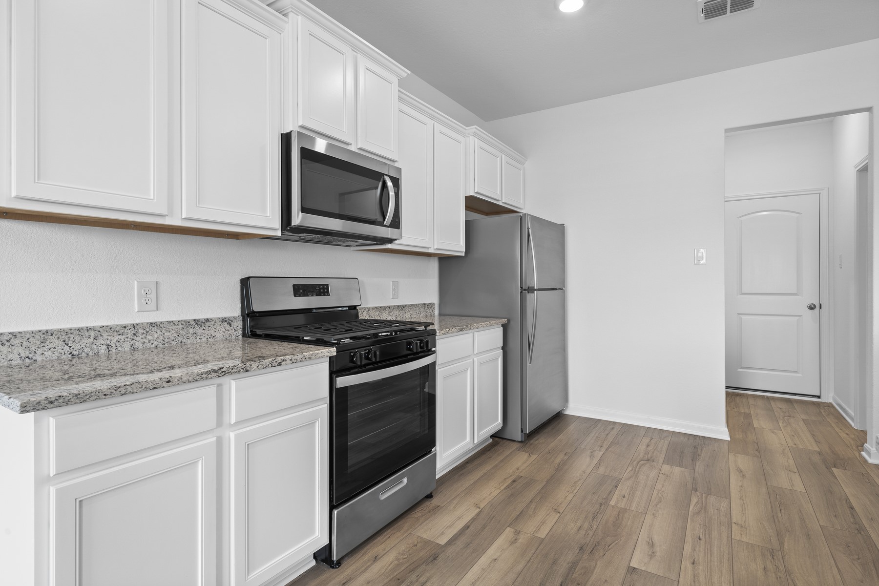 346 Low Pasture Trail Maxwell, TX 78656 - Photo 2 of 9 a kitchen with stainless steel appliances granite countertop a stove a refrigerator and a microwave