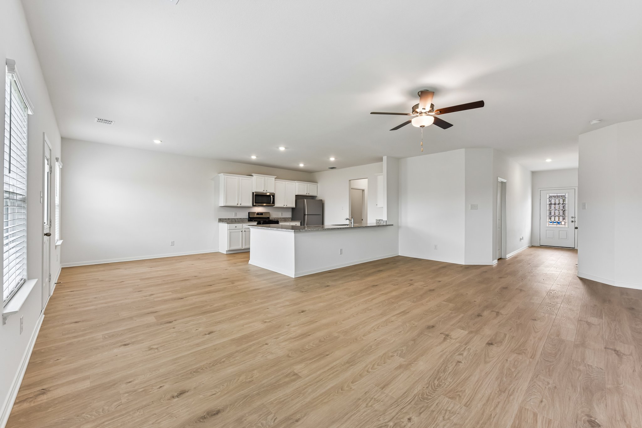346 Low Pasture Trail Maxwell, TX 78656 - Photo 4 of 29 Open-concept living space featuring wood-finish flooring, recessed lighting, and a ceiling fan