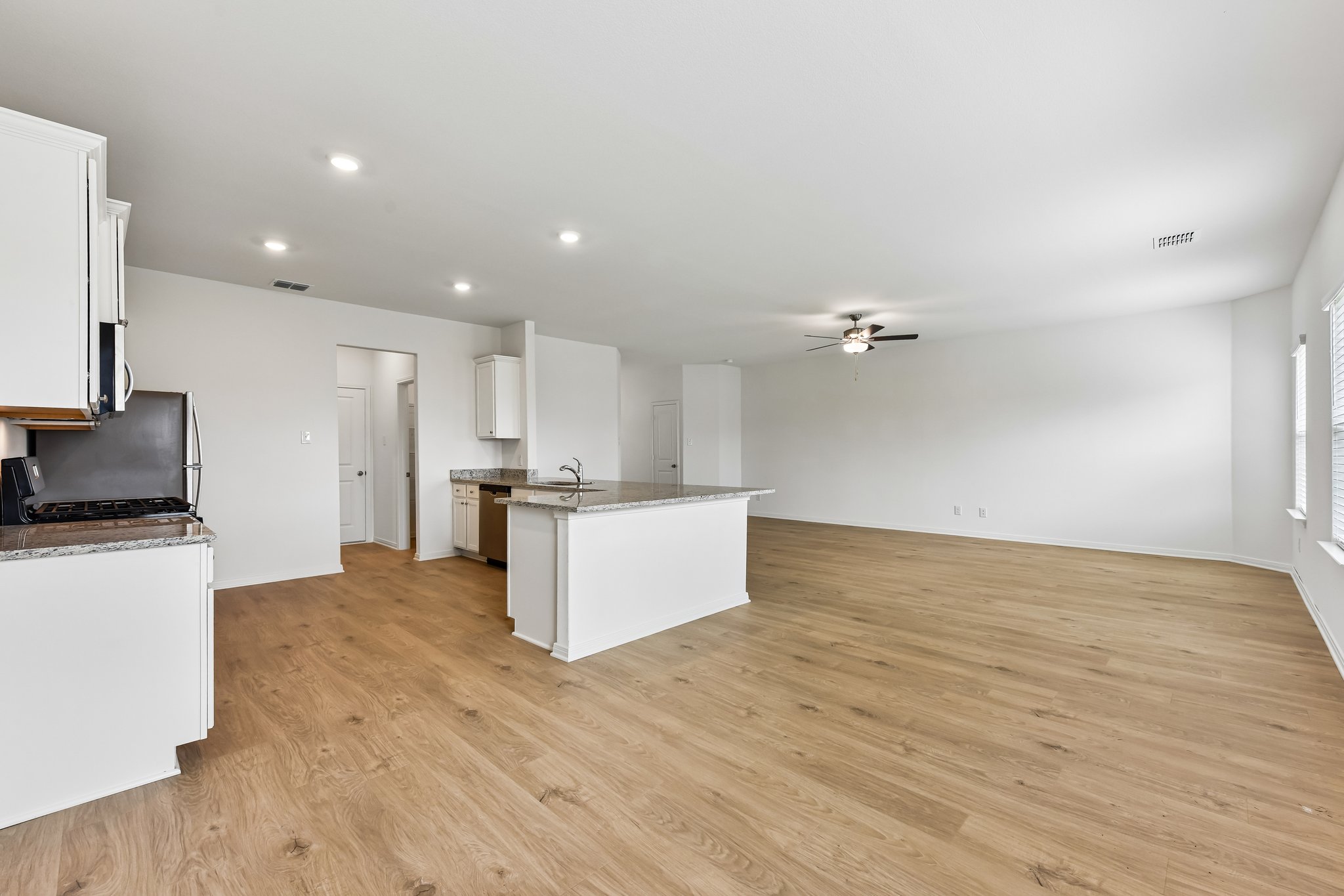 346 Low Pasture Trail Maxwell, TX 78656 - Photo 6 of 29 Open-concept living space featuring wood-finish flooring, recessed lighting, and a ceiling fan