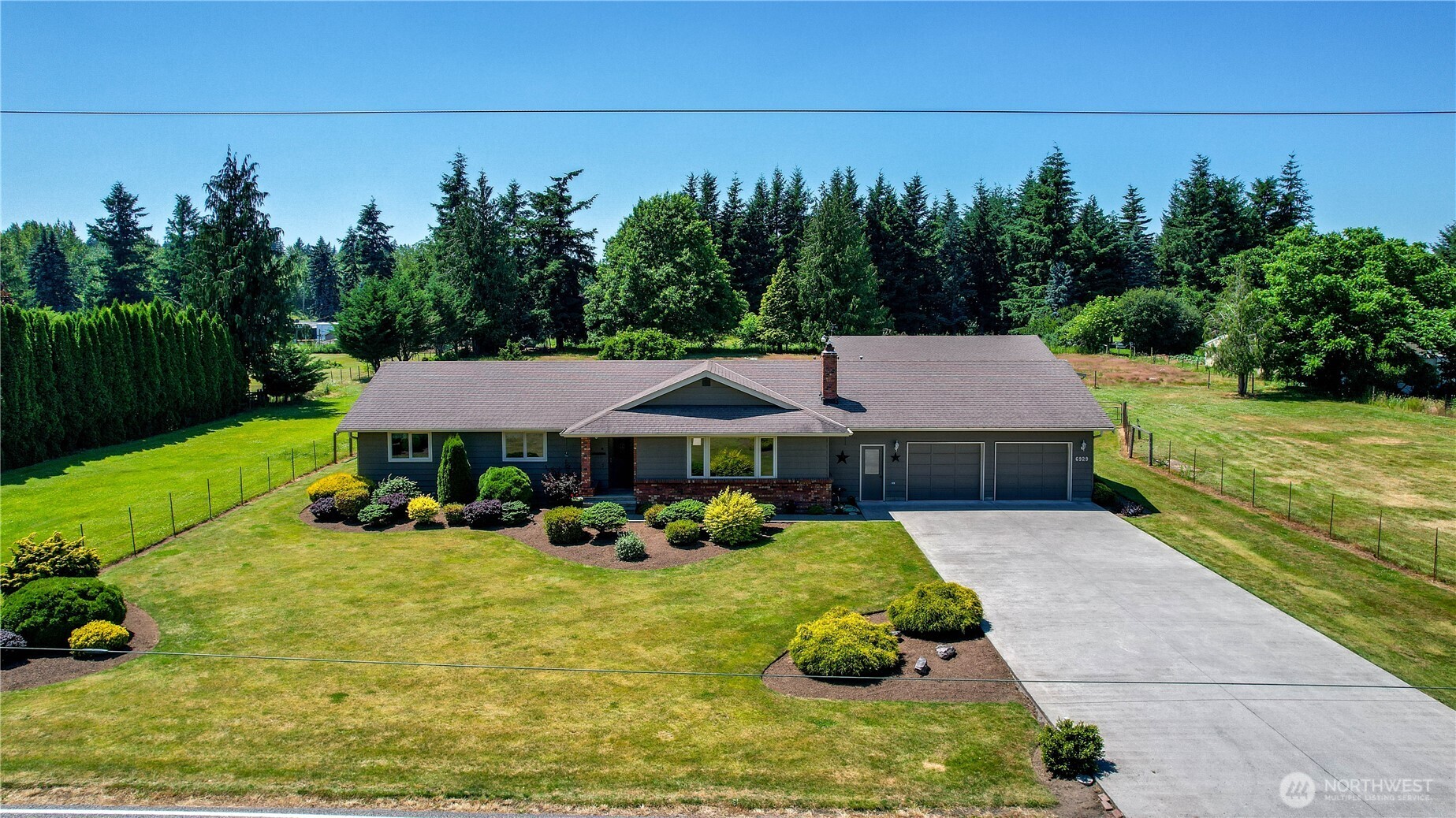 6929 Mission Road Everson, WA 98247 - Photo 1 of 36 a view of a house with backyard sitting area and garden