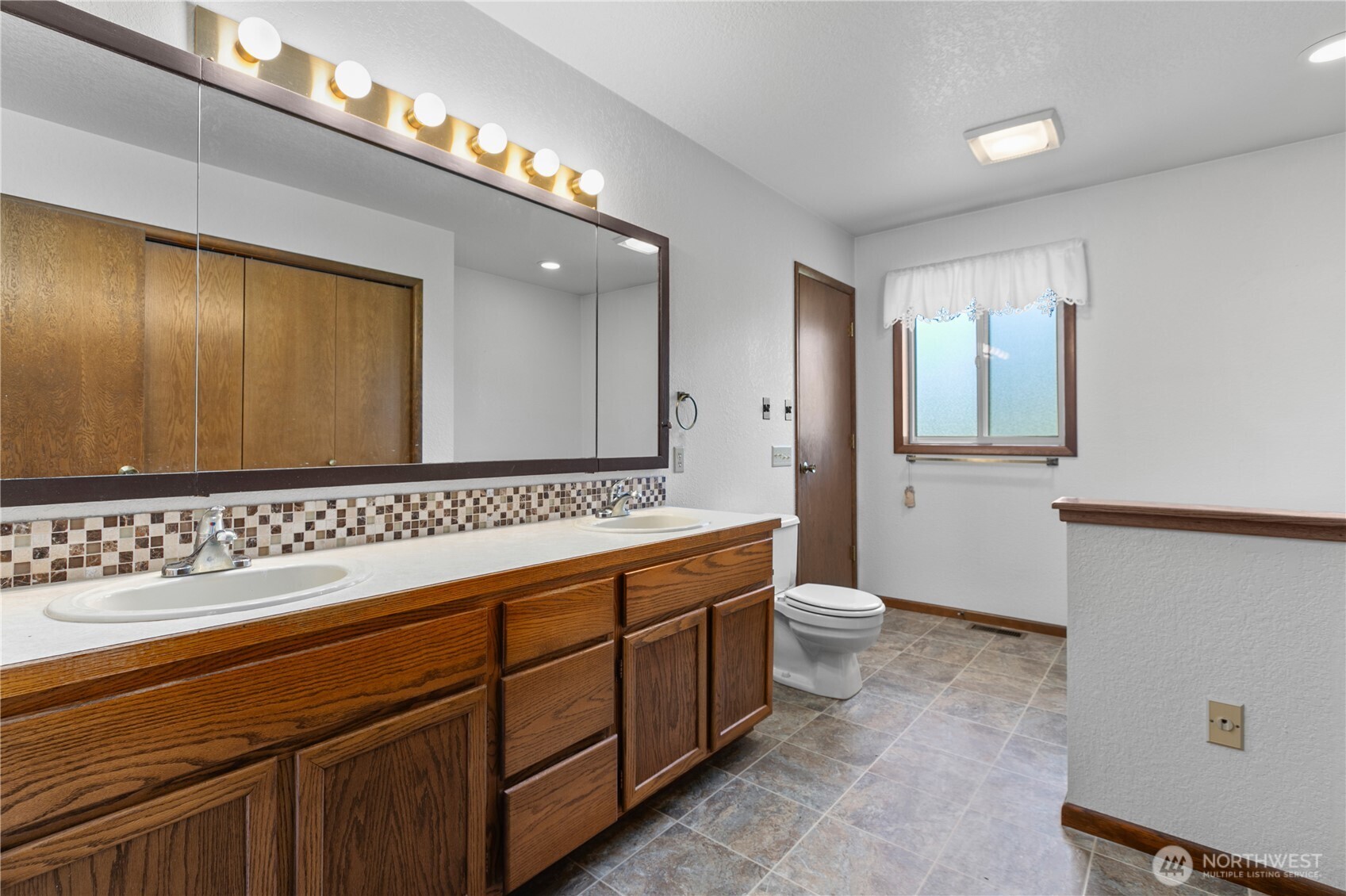 6929 Mission Road Everson, WA 98247 - Photo 14 of 36 a bathroom with a double vanity sink and a mirror