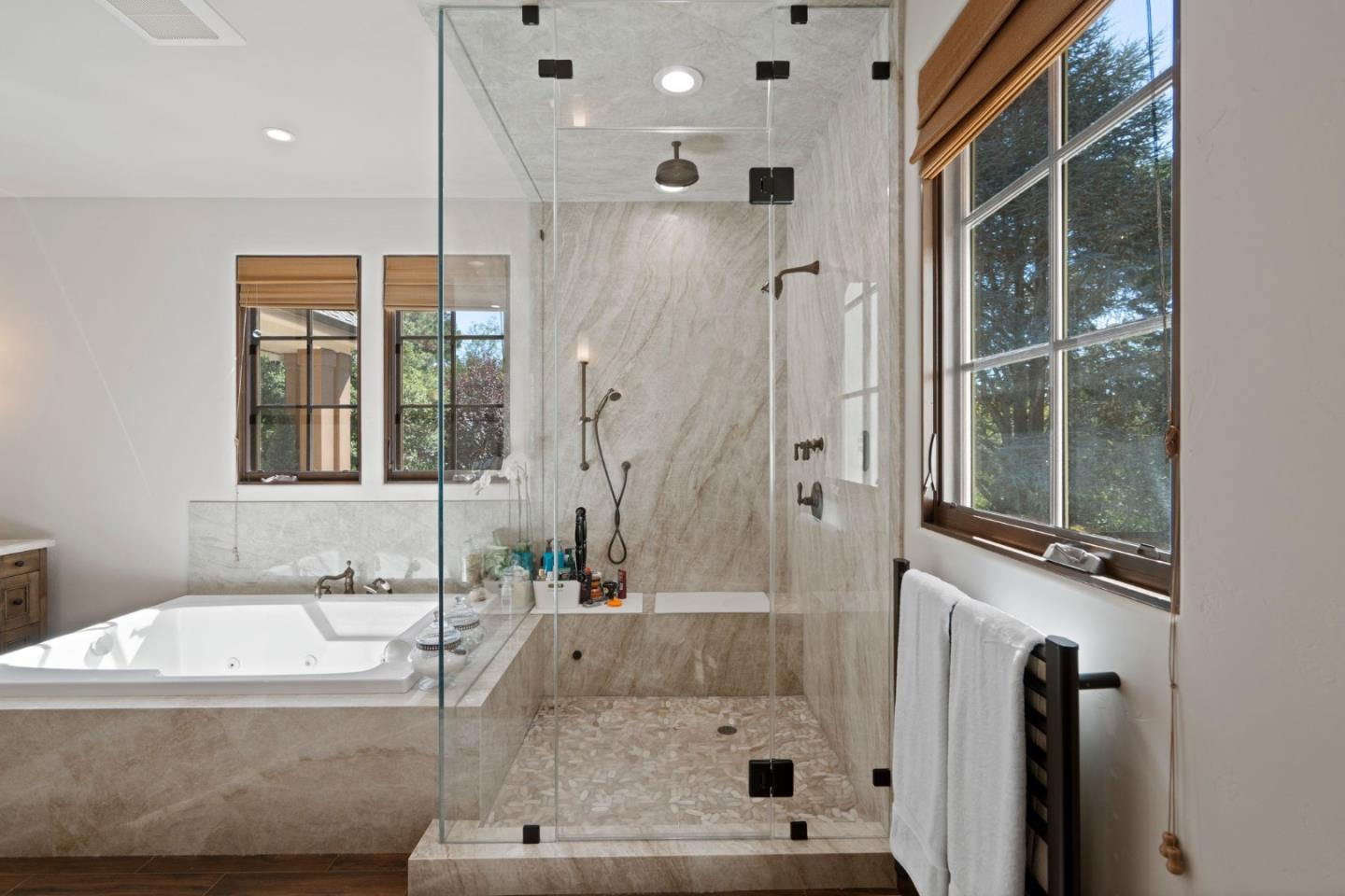 70 Joyce Road Hillsborough, CA 94010 - Photo 62 of 100 a bathroom with a tub a sink and a large mirror