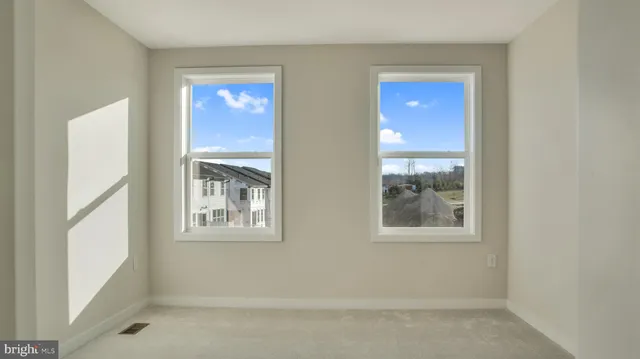 a view of wooden floor and windows in a room