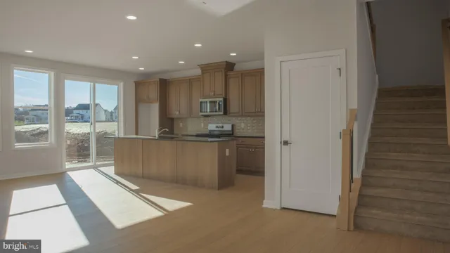 a view of kitchen with refrigerator and window