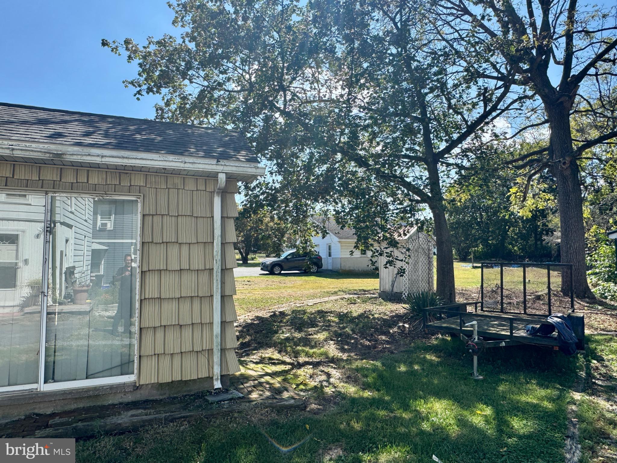 895 Pleasant Hill Road Fleetwood, PA 19522 - Photo 14 of 36 a backyard of a house with lawn chairs and a fire pit