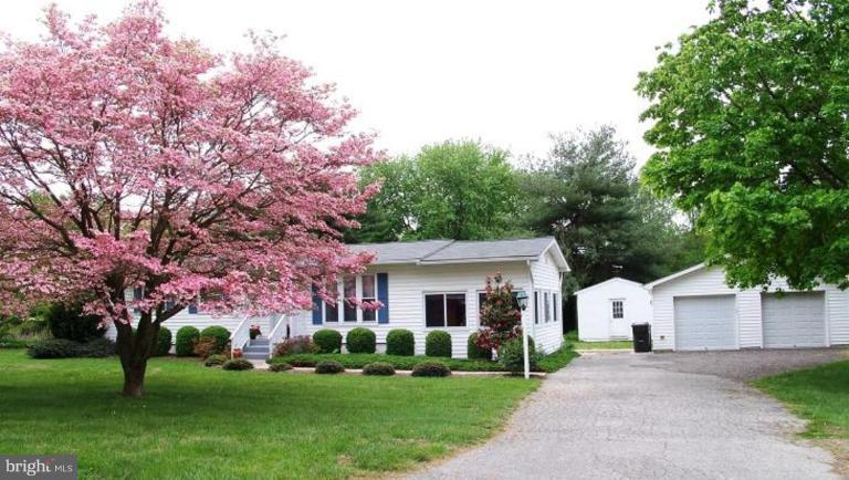 2035 Papas Lane Lusby, MD 20657 - Photo 1 of 12 a front view of a house with a garden and trees