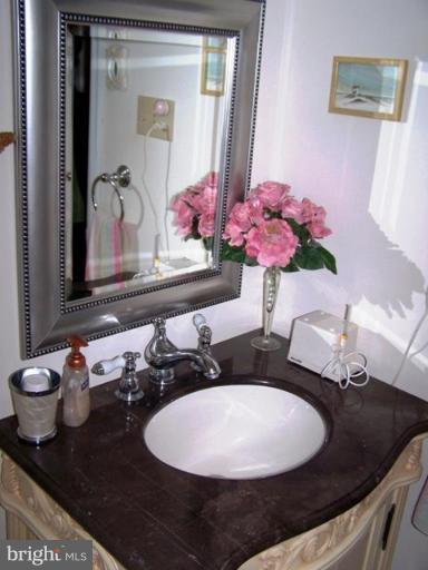 2035 Papas Lane Lusby, MD 20657 - Photo 3 of 12 a bathroom with a granite countertop sink and a mirror