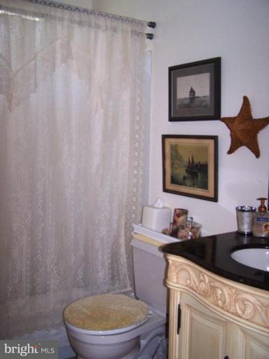 2035 Papas Lane Lusby, MD 20657 - Photo 4 of 12 a bathroom with a toilet a sink and a shower curtain