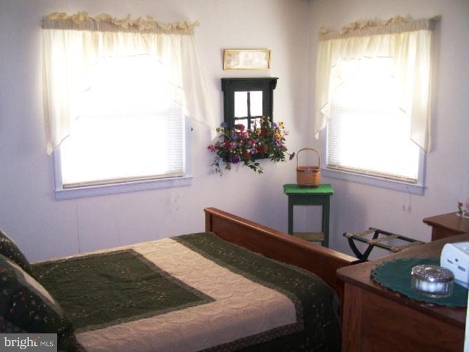 2035 Papas Lane Lusby, MD 20657 - Photo 5 of 12 a bedroom with a bed table and a window