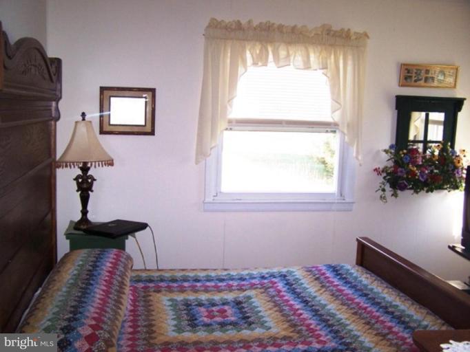 2035 Papas Lane Lusby, MD 20657 - Photo 6 of 12 a bedroom with a bed and a window