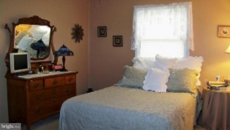2035 Papas Lane Lusby, MD 20657 - Photo 10 of 12 a bedroom with a bed and a mirror
