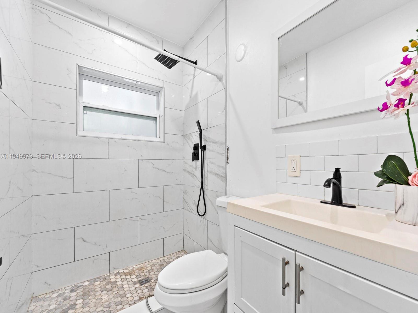 1230 Northwest 35th Street Miami, FL 33142 - Photo 12 of 36 a bathroom with a sink a toilet and shower