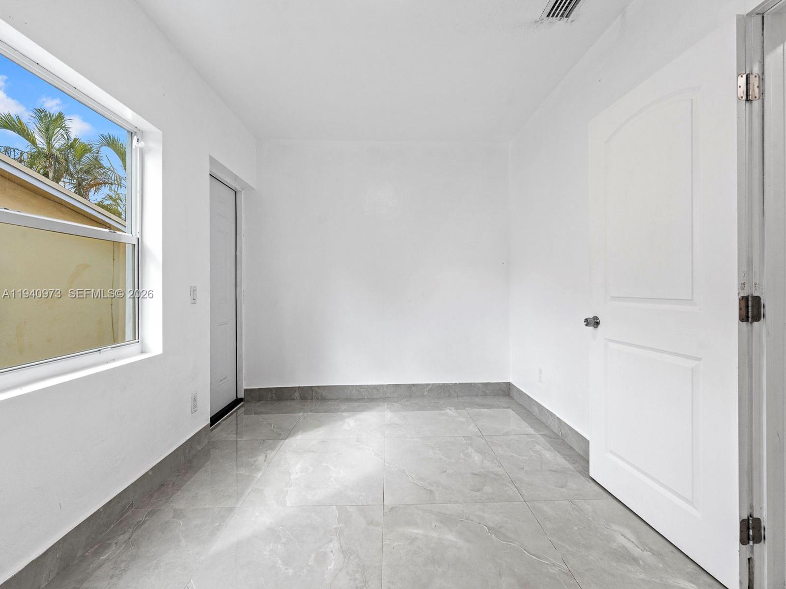 1230 Northwest 35th Street Miami, FL 33142 - Photo 16 of 36 an empty room with windows