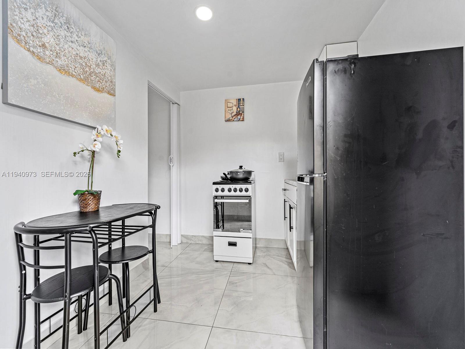 1230 Northwest 35th Street Miami, FL 33142 - Photo 18 of 36 a kitchen with a refrigerator and cabinets