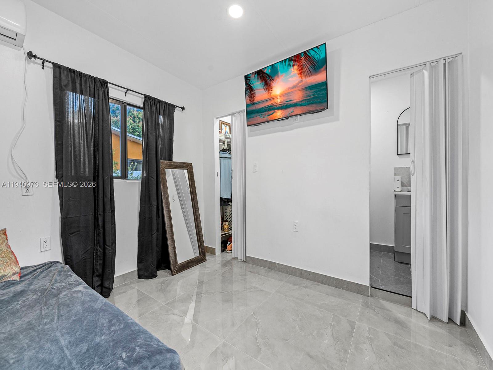 1230 Northwest 35th Street Miami, FL 33142 - Photo 26 of 36 a view of a livingroom with furniture and a window