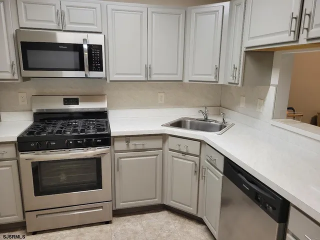 a kitchen with cabinets and white appliances